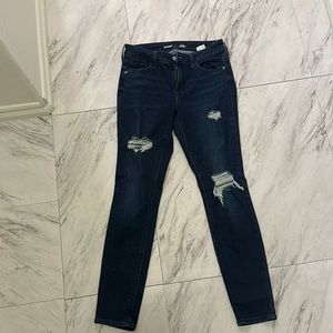 Mid rise skinny jeans. Size 4 with holes